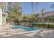 Relaxing pool area featuring a waterfall, lush greenery, and ample seating for outdoor enjoyment at 420 Pinnacle Heights Ln, Las Vegas, NV 89144