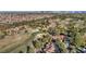 Aerial view of the community, golf course, and city skyline beyond the trees at 4961 Tierra Del Sol Dr, Las Vegas, NV 89113