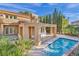 Inviting backyard pool area featuring a tiled pool, covered patio, lush greenery, and a tranquil outdoor oasis at 4961 Tierra Del Sol Dr, Las Vegas, NV 89113