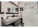 Bright bathroom featuring a vanity, framed mirror, and walk-in shower with marble tile at 4961 Tierra Del Sol Dr, Las Vegas, NV 89113