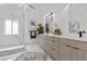 Sleek bathroom with dual vanities, quartz countertops, a modern shower with glass enclosure, and stylish fixtures at 4961 Tierra Del Sol Dr, Las Vegas, NV 89113