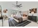 Spacious bedroom with a vaulted ceiling, ceiling fan, and plush bed at 4961 Tierra Del Sol Dr, Las Vegas, NV 89113