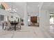 Elegant dining room with a modern chandelier, a fireplace, and seamless access to the living room at 4961 Tierra Del Sol Dr, Las Vegas, NV 89113