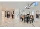 Elegant dining room featuring a modern chandelier, open layout, and seamless flow to the kitchen at 4961 Tierra Del Sol Dr, Las Vegas, NV 89113