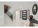 Bright and modern foyer with marble floors, a staircase, and a stylish front door with sidelights at 4961 Tierra Del Sol Dr, Las Vegas, NV 89113