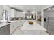 Gourmet kitchen boasts white cabinetry, stainless steel appliances, and a large island with quartz countertops at 4961 Tierra Del Sol Dr, Las Vegas, NV 89113