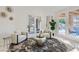 Bright living room with marble floors, a modern rug, and doors to the outdoor patio at 4961 Tierra Del Sol Dr, Las Vegas, NV 89113