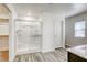 Modern bathroom featuring a glass shower, wood look floors, and granite vanity at 4991 Amberlyn St, Las Vegas, NV 89122