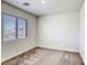 Neutral bedroom with large window and view of neighborhood in distance at 4991 Amberlyn St, Las Vegas, NV 89122