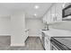 Bright white kitchen with stainless steel appliances, quartz countertops, and modern black hardware at 5009 Indian River Dr # 153, Las Vegas, NV 89103