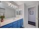 Bright bathroom featuring blue vanity, white countertops, and updated fixtures at 5508 Lochmor Ave, Las Vegas, NV 89130