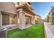 A quaint backyard provides a private outdoor space with artificial turf and a covered patio area at 600 N Carriage Hill Dr # 1143, Las Vegas, NV 89138