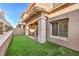 A quaint backyard provides a private outdoor space with artificial turf and a covered patio area at 600 N Carriage Hill Dr # 1143, Las Vegas, NV 89138