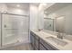 Elegant bathroom with double sinks, modern fixtures, and a sleek glass-enclosed shower at 600 N Carriage Hill Dr # 1143, Las Vegas, NV 89138