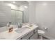 Clean bathroom features vanity with gray cabinets and a glass-enclosed shower at 600 N Carriage Hill Dr # 1143, Las Vegas, NV 89138