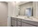Modern bathroom featuring double sinks, sleek countertops, and a large mirror reflecting the space at 600 N Carriage Hill Dr # 1143, Las Vegas, NV 89138