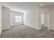 Spacious bedroom with neutral carpet, window with blinds, base trim, and white walls at 600 N Carriage Hill Dr # 1143, Las Vegas, NV 89138