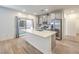 Modern kitchen with stainless steel appliances, gray cabinets, an island, and sliding door to the yard at 600 N Carriage Hill Dr # 1143, Las Vegas, NV 89138