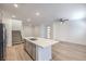 Open concept living space featuring recessed lighting, stairs, a large island, and wood flooring at 600 N Carriage Hill Dr # 1143, Las Vegas, NV 89138