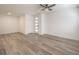 Bright living room with light wood flooring, white walls, and modern ceiling fan with light fixture at 600 N Carriage Hill Dr # 1143, Las Vegas, NV 89138