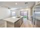 Bright living space with stainless steel appliances, an island, and a sliding door to the yard at 600 N Carriage Hill Dr # 1143, Las Vegas, NV 89138