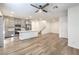 Open-concept living room and kitchen with stainless steel appliances, light wood floors, and a kitchen island at 600 N Carriage Hill Dr # 1143, Las Vegas, NV 89138
