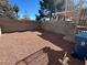 Enclosed backyard with desert landscaping, a spiral staircase, and a privacy wall at 6104 Hillside Bloom Ct # 201, Las Vegas, NV 89130