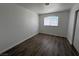 Bright bedroom featuring a window with sheer curtains and wood floors at 6104 Hillside Bloom Ct # 201, Las Vegas, NV 89130