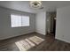 Bright bedroom featuring a ceiling fan, wood floors, and natural light from a window with sheer curtains at 6104 Hillside Bloom Ct # 201, Las Vegas, NV 89130