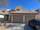 Attractive townhome with a two-car garage and manicured shrubbery at 6104 Hillside Bloom Ct # 201, Las Vegas, NV 89130