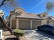 Charming townhome featuring a two-car garage and desert landscaping at 6104 Hillside Bloom Ct # 201, Las Vegas, NV 89130