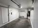 Clean garage with storage shelving and a freshly painted interior at 6104 Hillside Bloom Ct # 201, Las Vegas, NV 89130
