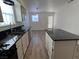 Open concept kitchen with island, stainless steel appliances, and wood grain flooring at 6104 Hillside Bloom Ct # 201, Las Vegas, NV 89130