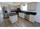 A modern kitchen features stainless steel appliances, an island, and granite countertops at 6104 Hillside Bloom Ct # 201, Las Vegas, NV 89130