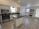 Bright kitchen with a center island, stainless steel appliances, and a cozy dining nook at 6104 Hillside Bloom Ct # 201, Las Vegas, NV 89130