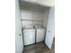 Convenient laundry closet featuring a washer and dryer, and plenty of shelving for storage at 6104 Hillside Bloom Ct # 201, Las Vegas, NV 89130