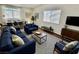 Bright living room featuring stylish blue sofas and a view into the dining area at 6104 Hillside Bloom Ct # 201, Las Vegas, NV 89130