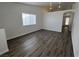 Bright living room featuring wood-look floors, vaulted ceilings, and plenty of natural light at 6104 Hillside Bloom Ct # 201, Las Vegas, NV 89130
