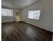 Spacious living room with wood-look flooring and ample natural light at 6104 Hillside Bloom Ct # 201, Las Vegas, NV 89130