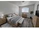 Comfortable bedroom with wood-style flooring, a large window, and ample natural light at 6104 Hillside Bloom Ct # 201, Las Vegas, NV 89130