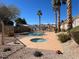Community pool and spa surrounded by lush landscaping and mature palm trees at 6104 Hillside Bloom Ct # 201, Las Vegas, NV 89130