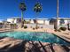 Community pool with desert landscaping and towering palm trees under a clear blue sky at 6104 Hillside Bloom Ct # 201, Las Vegas, NV 89130