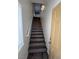 Stairway with wood-look treads, leading to the upper level of the home at 6104 Hillside Bloom Ct # 201, Las Vegas, NV 89130