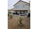 Backyard with a covered patio area, dirt ground, and small trees in planters at 6624 Socorro Dr, Las Vegas, NV 89108