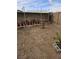 Backyard area with a dirt ground, block wall and some planters at 6624 Socorro Dr, Las Vegas, NV 89108