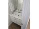 The bathroom sink has all-white cabinets, faucet, mirror, and a white towel hanging up at 6624 Socorro Dr, Las Vegas, NV 89108