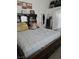 The bedroom has a dark wooden bed, mirrored dresser, mini fridge, and decor at 6624 Socorro Dr, Las Vegas, NV 89108