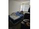 Bedroom with a large window for natural light and a neatly made bed with unique bedding at 6624 Socorro Dr, Las Vegas, NV 89108