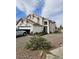 Front exterior of a two-story home with stucco exterior and an attached garage at 6624 Socorro Dr, Las Vegas, NV 89108
