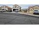 Front exterior of a two-story house with neutral stucco, tile roof, and an attached garage at 6624 Socorro Dr, Las Vegas, NV 89108